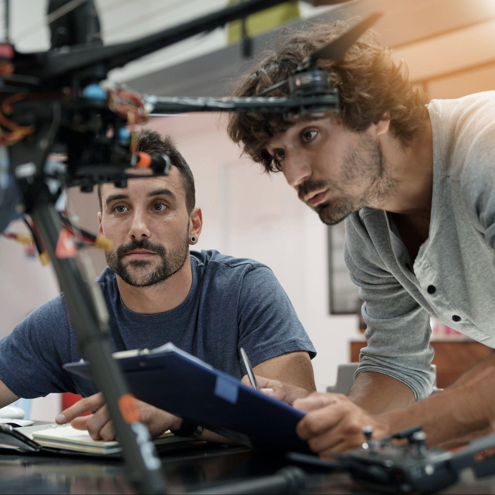 Two engineers inspecting an assembly against the acceptance criteria