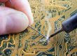 soldering with a soldering iron and lead on a board